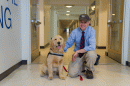 UNH professor Ray Cook and therapy-dog-in-training Tucker