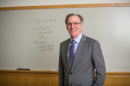 Marketing professor Tom Gruen poses in front of a white board