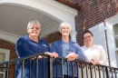 Penny Watson, Karen Gilbert, Jessica Willis on steps behind Hood House
