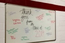 A whiteboard with various colleges and university names written on it