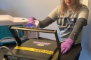 Castine Bernardy working on disinfecting gloves 