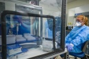 Student dressed in protective equipment working in COVID testing lab