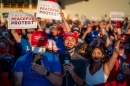 A group of people wearing Trump 2020 gear at a Trump rally.