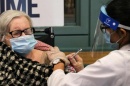 Photo of elderly woman receiving the COVID-19 vaccination
