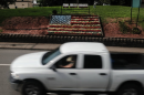 White pickup truck drives on a rural town in America