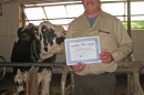 Jon Whitehouse with cow and award