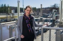 Paula Mouser stands on catwalk at Durham's wastewater treatment facility