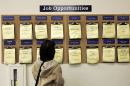 Female looks at a job board.