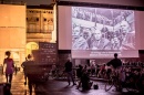 film screening outside in Bologna with large audience watching