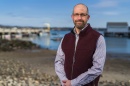 David Fredriksson stands by the UNH pier in New Castle.