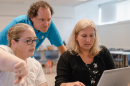 Three people at computer