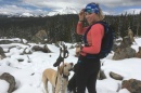 UNH student Georgi Fischer cross country skiing with her dog