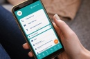 Hand holding smarphone with uSafeUS app open