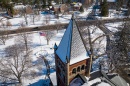 Aerial view of brick clock tower with dusting of snow on top