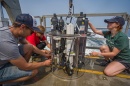 UNH students take water quality samples in the Gulf of Maine from aboard a boat.