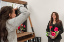 Kayla Vine ’25 takes a photo of Karen McNeil, owner of Mode Salon and Wellness in Manchester. 