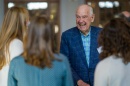 Dana Hamel smiles while interacting with three female students
