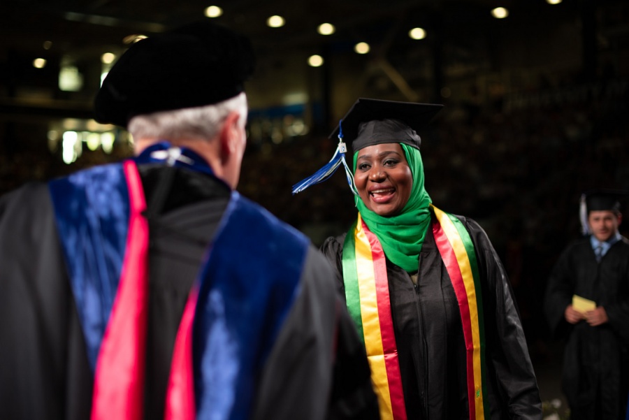 A UNH student receives their cord
