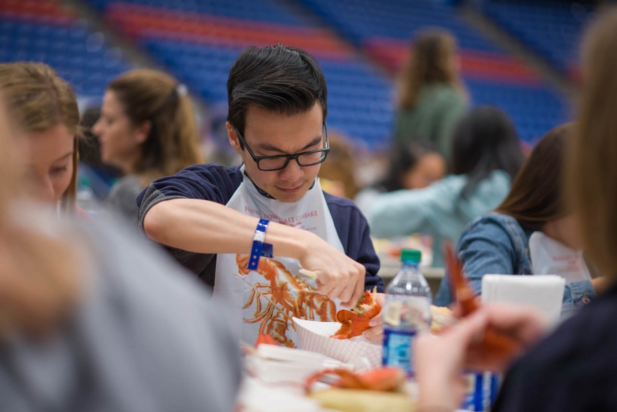 UNH seniors celebrating their impending graduation with classmates over lobster in the rough 