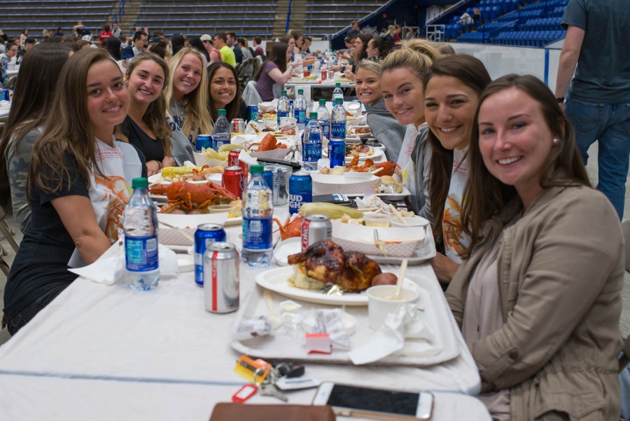 UNH seniors celebrating their impending graduation with classmates over lobster in the rough 