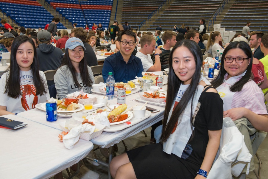 UNH seniors celebrating their impending graduation with classmates over lobster in the rough 