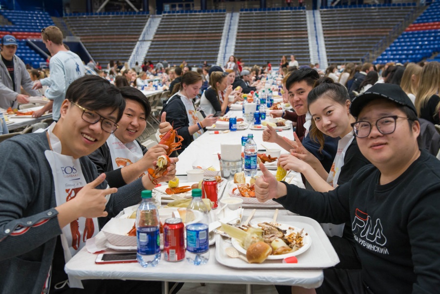 UNH seniors celebrating their impending graduation with classmates over lobster in the rough 