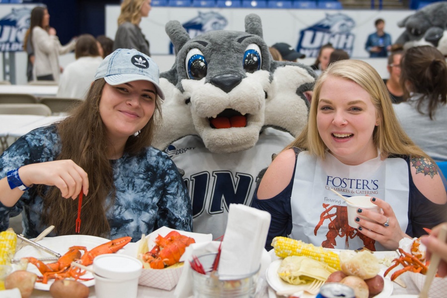 UNH seniors celebrating their impending graduation with classmates over lobster in the rough 