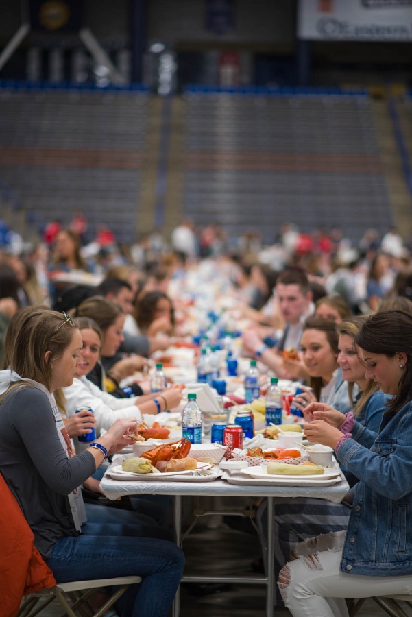 UNH seniors celebrating their impending graduation with classmates over lobster in the rough 