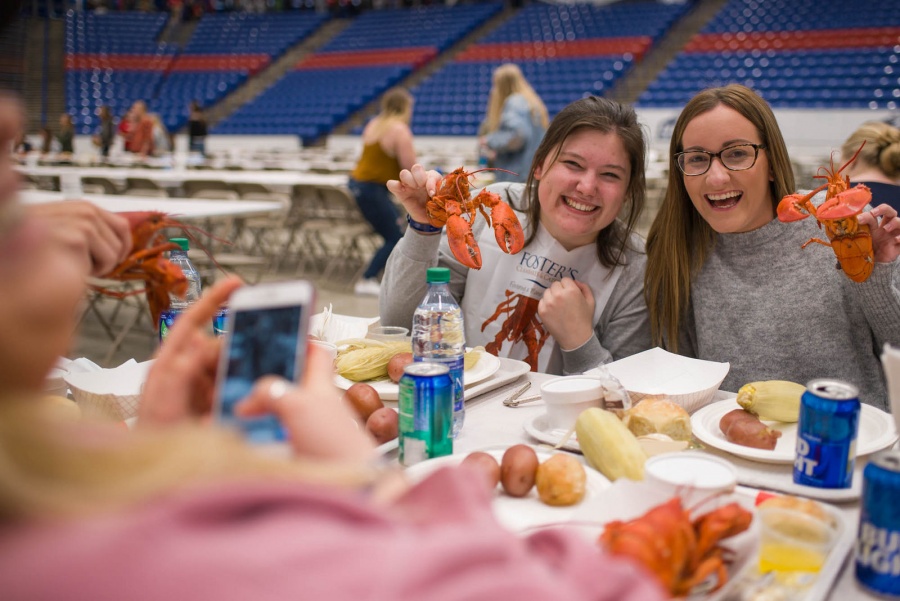 UNH seniors celebrating their impending graduation with classmates over lobster in the rough 