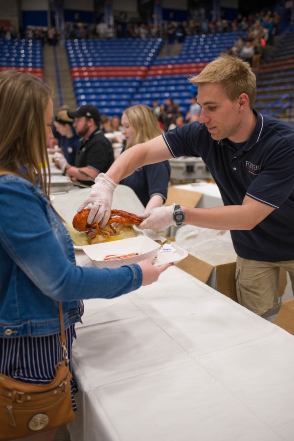 UNH seniors celebrating their impending graduation with classmates over lobster in the rough 