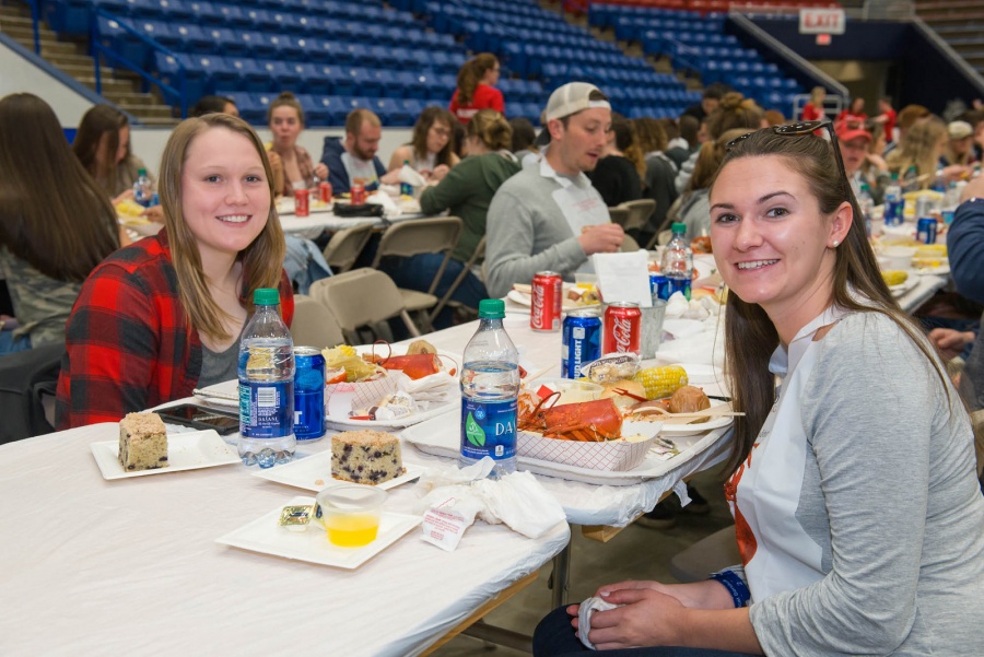 UNH seniors celebrating their impending graduation with classmates over lobster in the rough 