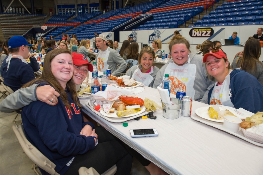 UNH seniors celebrating their impending graduation with classmates over lobster in the rough 