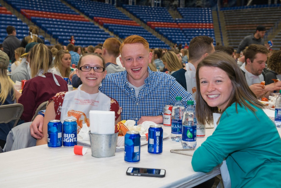 UNH seniors celebrating their impending graduation with classmates over lobster in the rough 