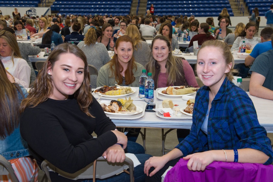 UNH seniors celebrating their impending graduation with classmates over lobster in the rough 