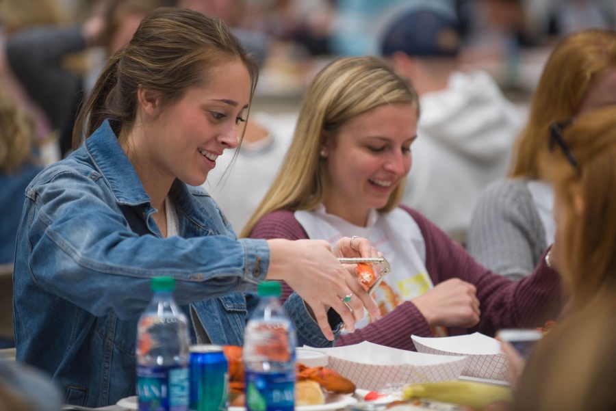 UNH seniors celebrating their impending graduation with classmates over lobster in the rough 