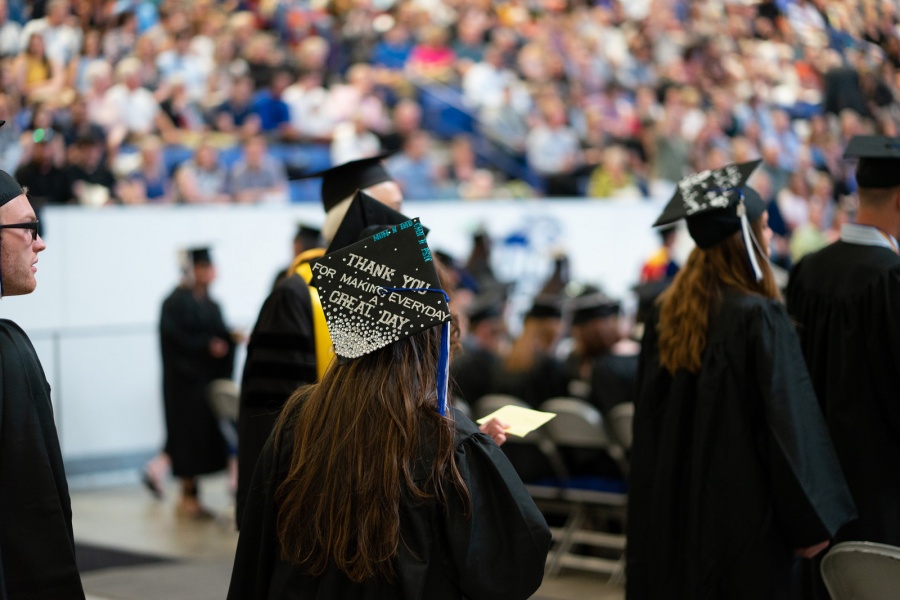 A UNH student receives their cord