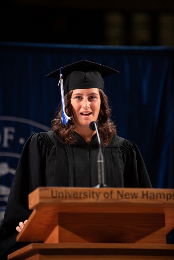 A UNH student receives their cord