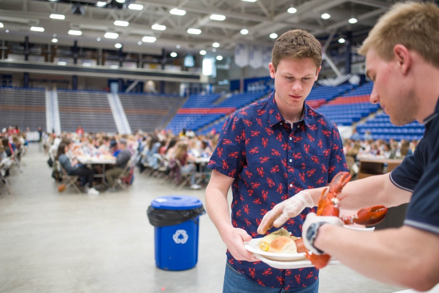 UNH seniors celebrating their impending graduation with classmates over lobster in the rough 