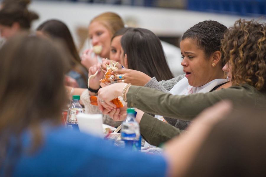 UNH seniors celebrating their impending graduation with classmates over lobster in the rough 