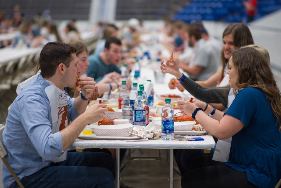 UNH seniors celebrating their impending graduation with classmates over lobster in the rough 