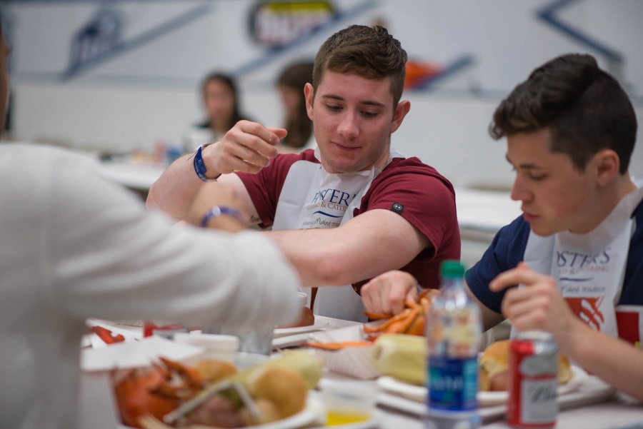 UNH seniors celebrating their impending graduation with classmates over lobster in the rough 