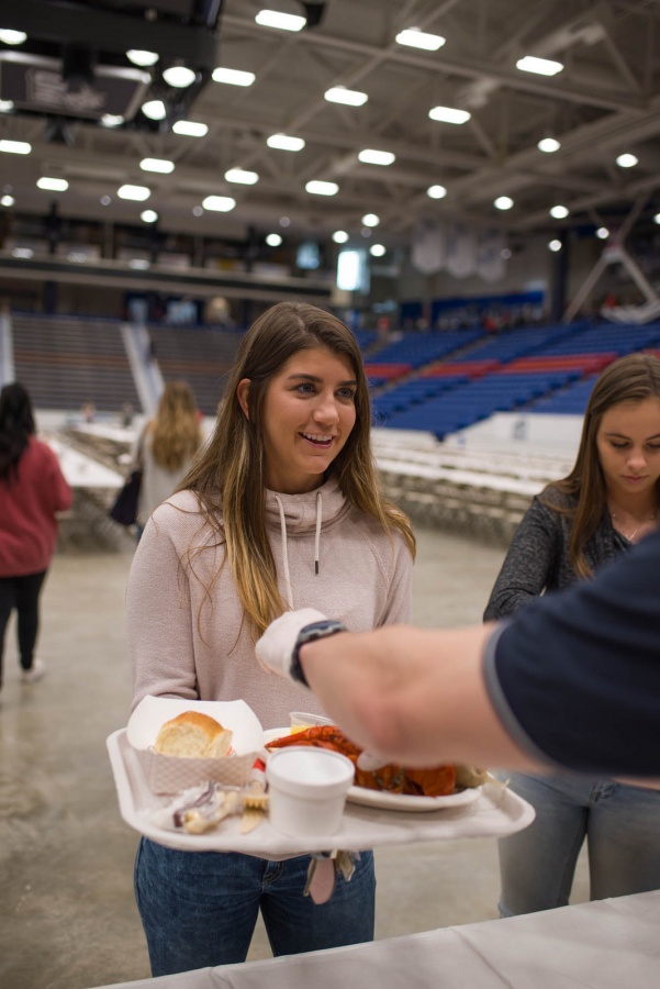UNH seniors celebrating their impending graduation with classmates over lobster in the rough 