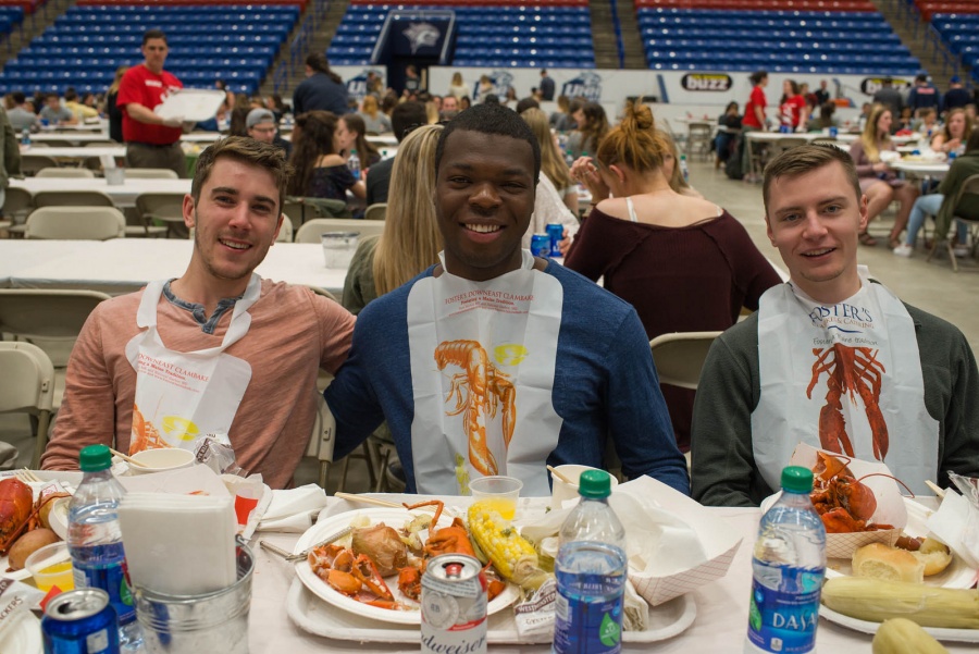 UNH seniors celebrating their impending graduation with classmates over lobster in the rough 