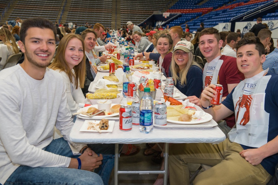 UNH seniors celebrating their impending graduation with classmates over lobster in the rough 