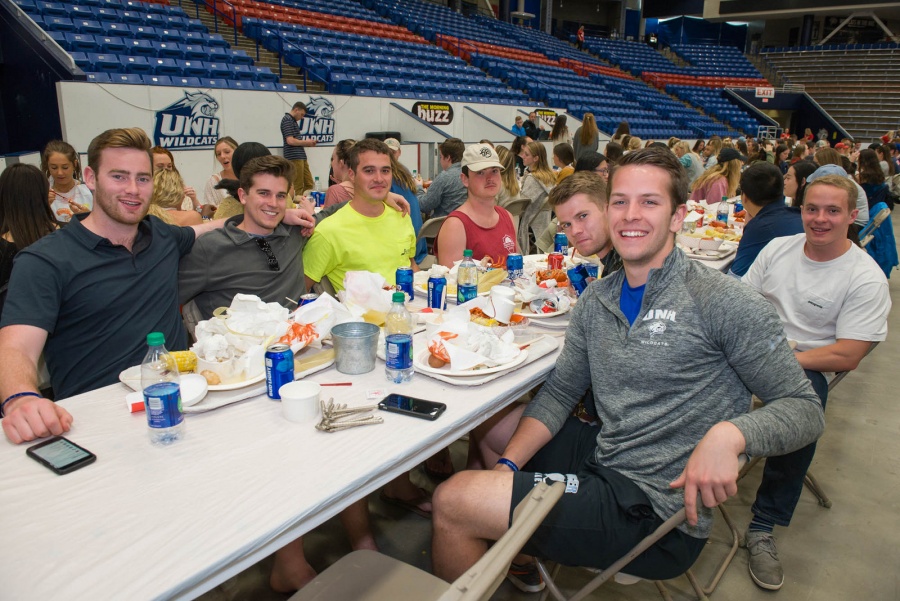UNH seniors celebrating their impending graduation with classmates over lobster in the rough 