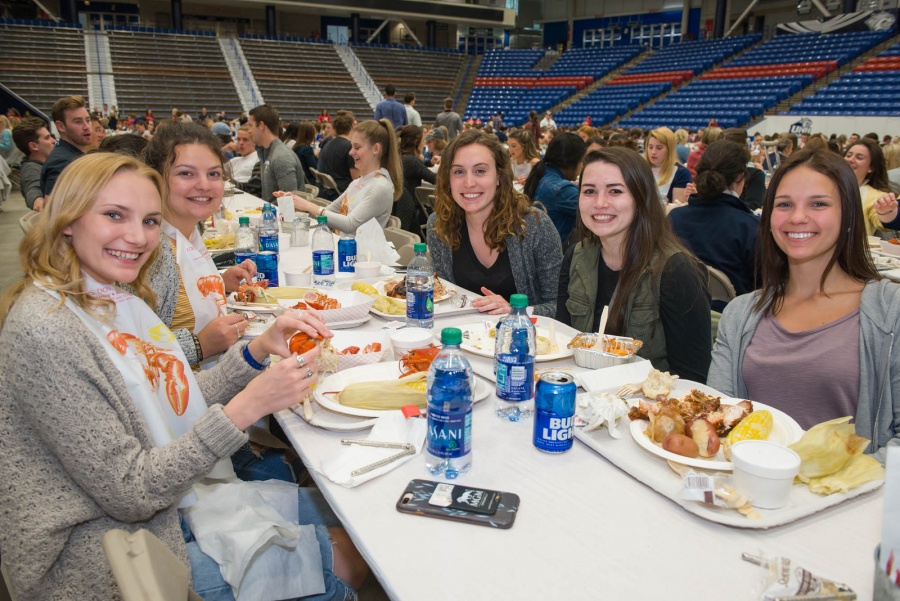UNH seniors celebrating their impending graduation with classmates over lobster in the rough 