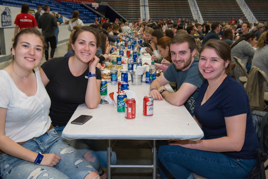 UNH seniors celebrating their impending graduation with classmates over lobster in the rough 