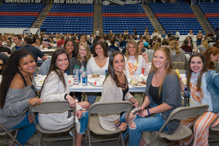 UNH seniors celebrating their impending graduation with classmates over lobster in the rough 