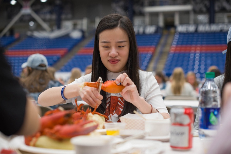 UNH seniors celebrating their impending graduation with classmates over lobster in the rough 