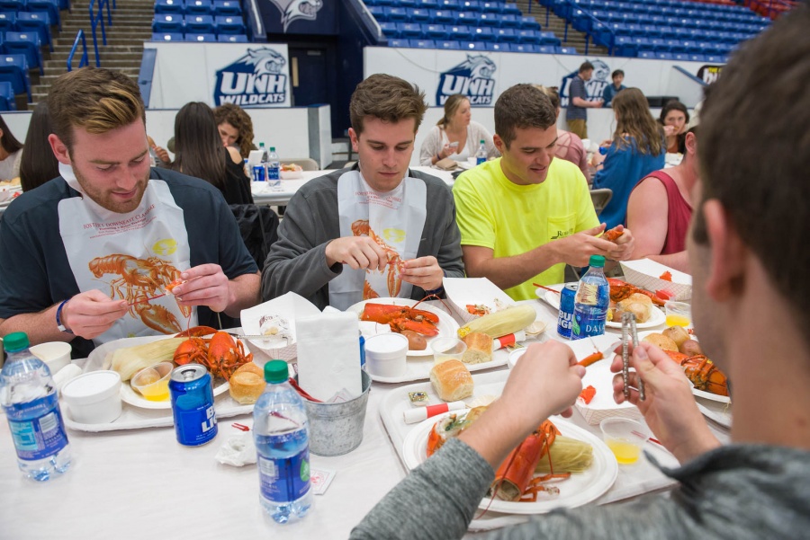 UNH seniors celebrating their impending graduation with classmates over lobster in the rough 